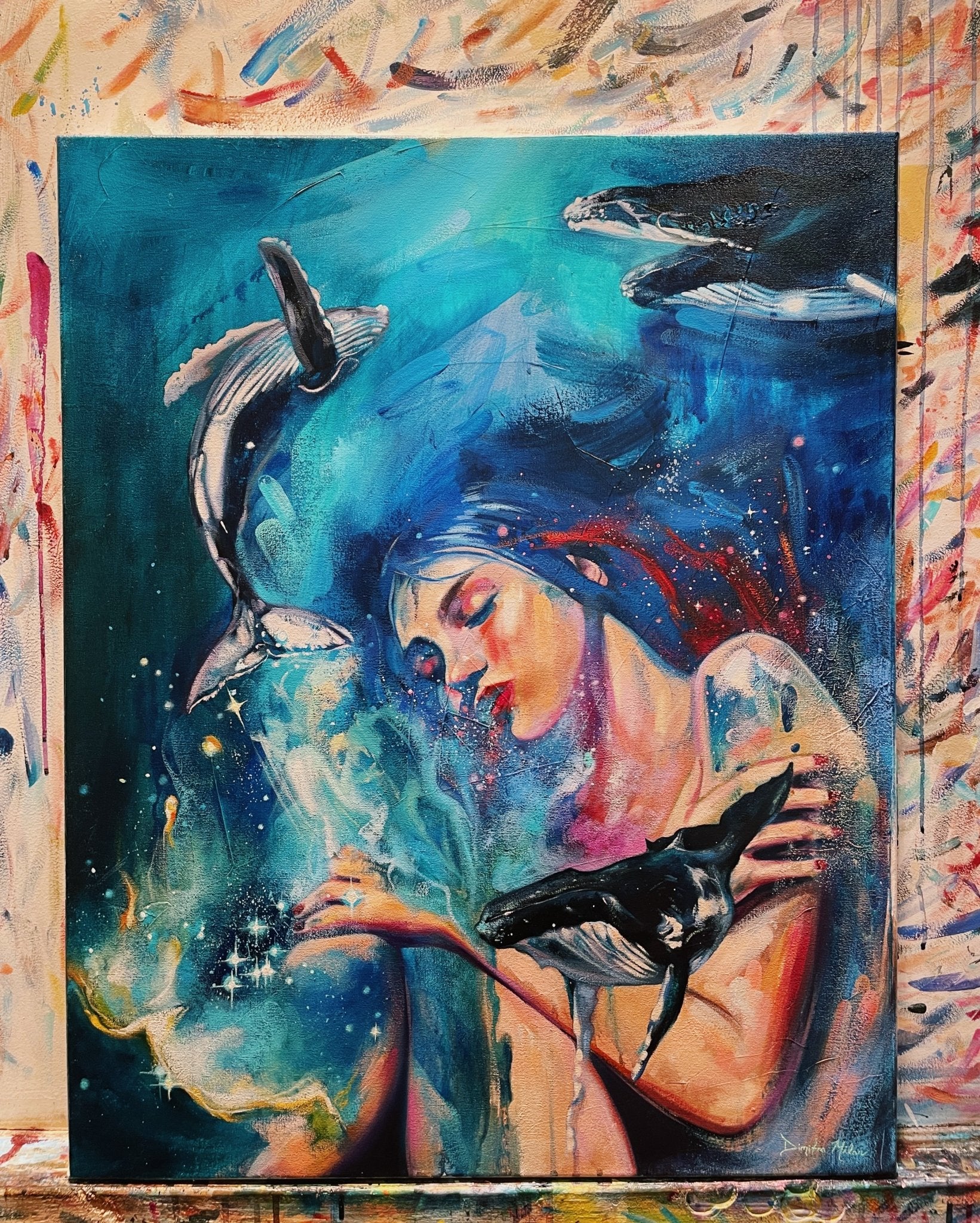 Deeper Still — a woman embracing whales in deep blue ocean waters